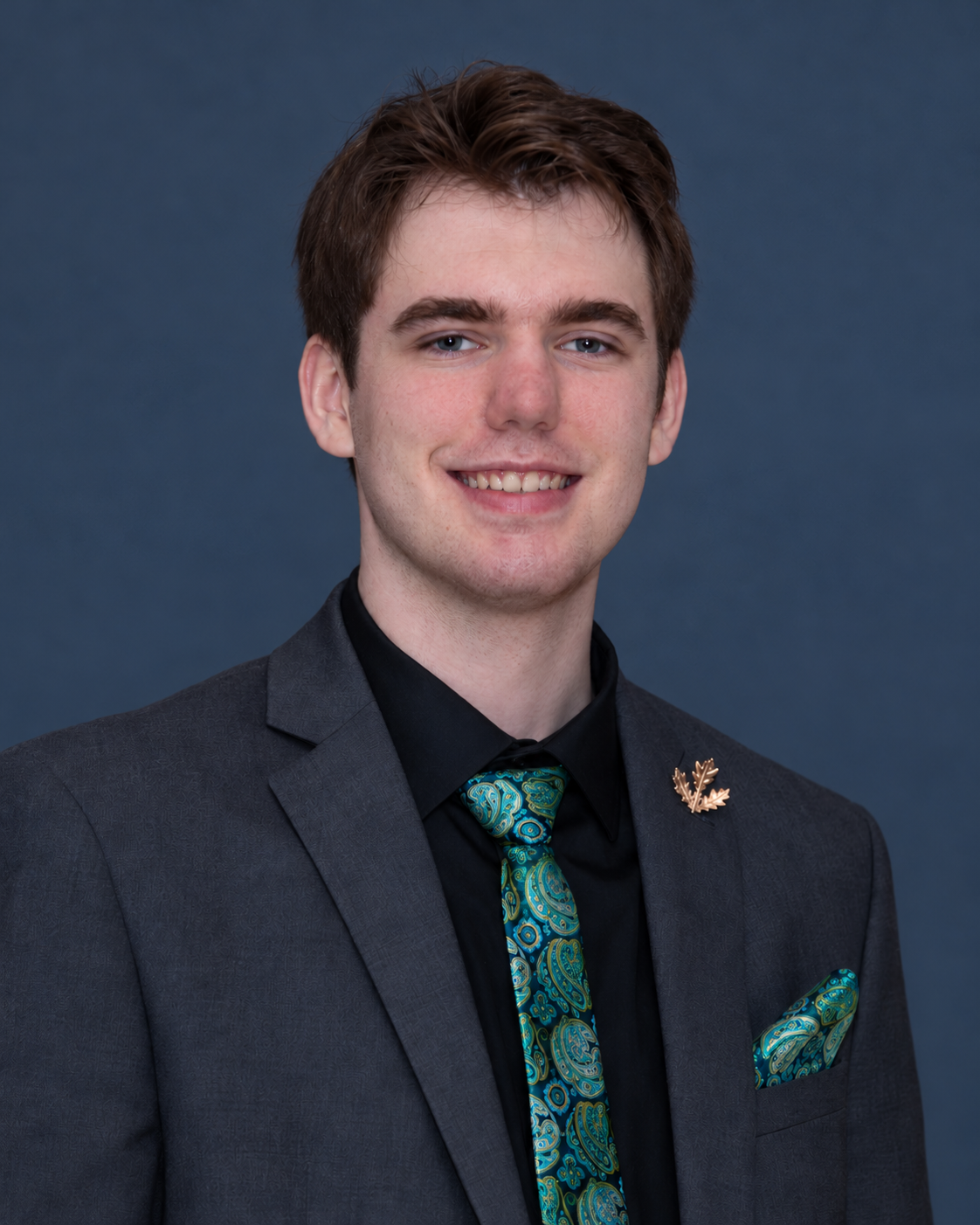 Kaleb Martin wearing a charcoal suit and teal tie